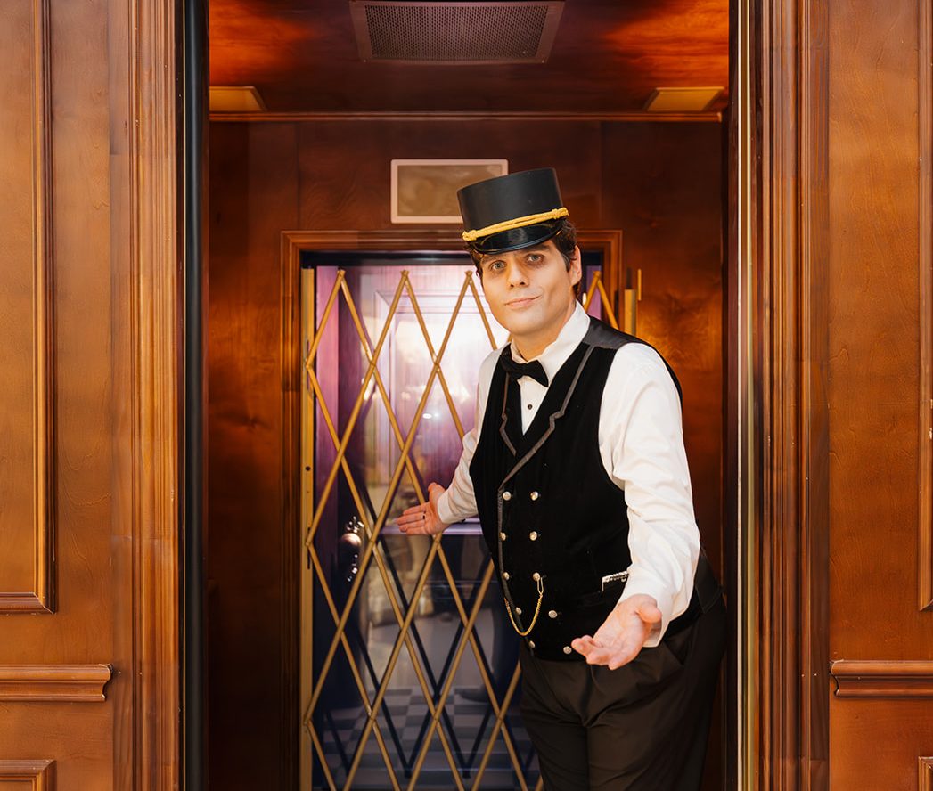 A ghost bellhop welcoming you into an elevator